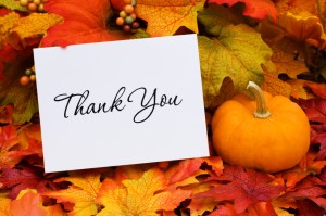 A thank you card with a gourd sitting on a fall leaf background, thank you